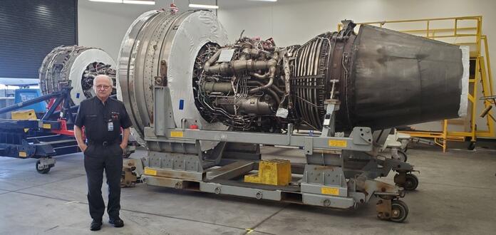 Jimmy posing in front of aircraft engine