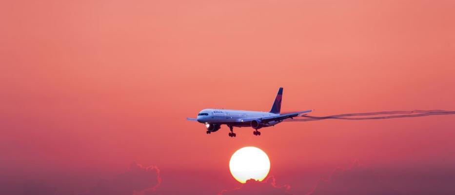 757-300 in flight with sunset