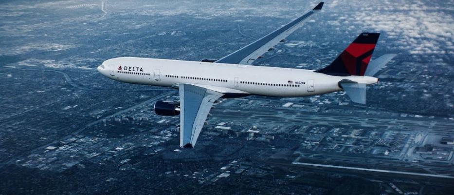 A330-300 in flight over city