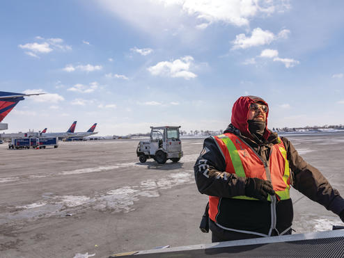A Delta Aircraft Load Agent works in winter conditions at Minneapolis-St. Paul International Airport (MSP).