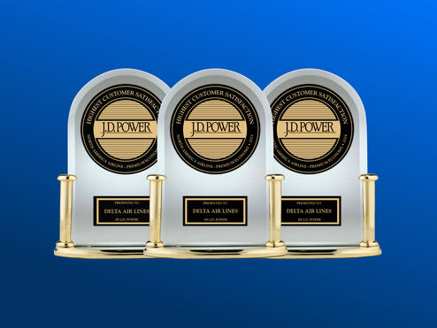 Three J.D. Power trophies against a blue background