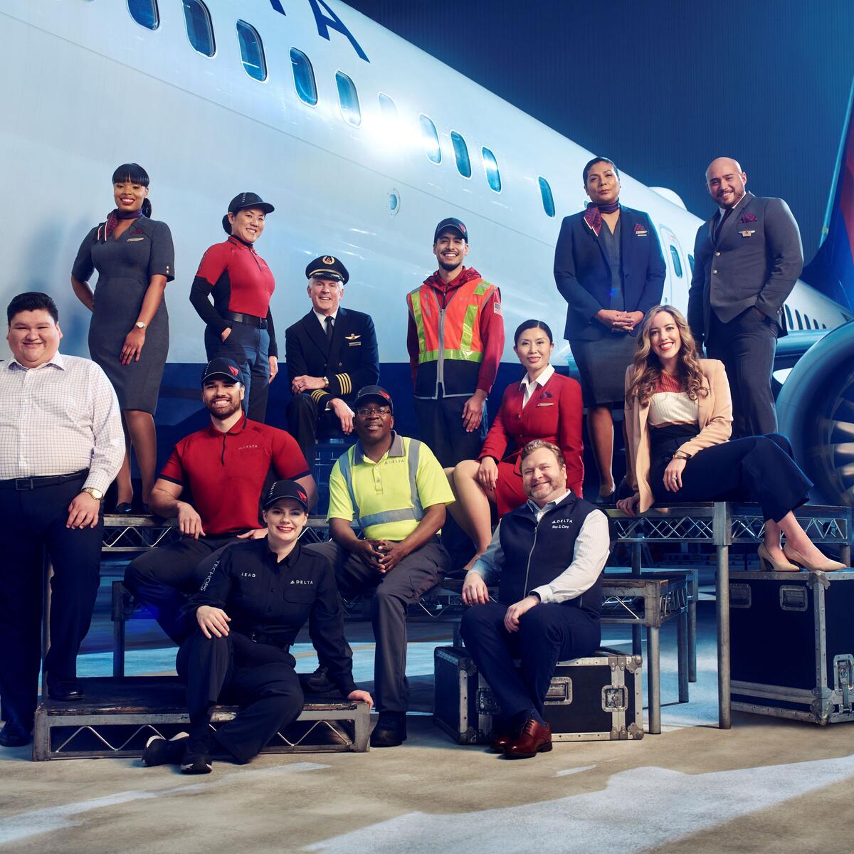Employees from across Delta's divisions pose in front of a plane in 2023.