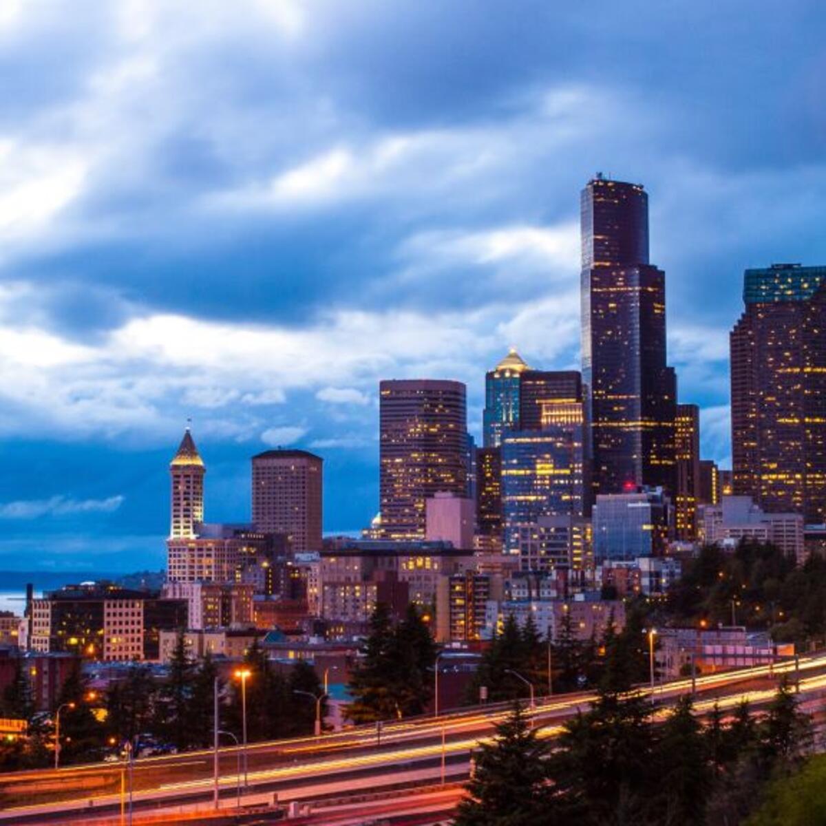 An image of downtown Seattle, lit up at night.