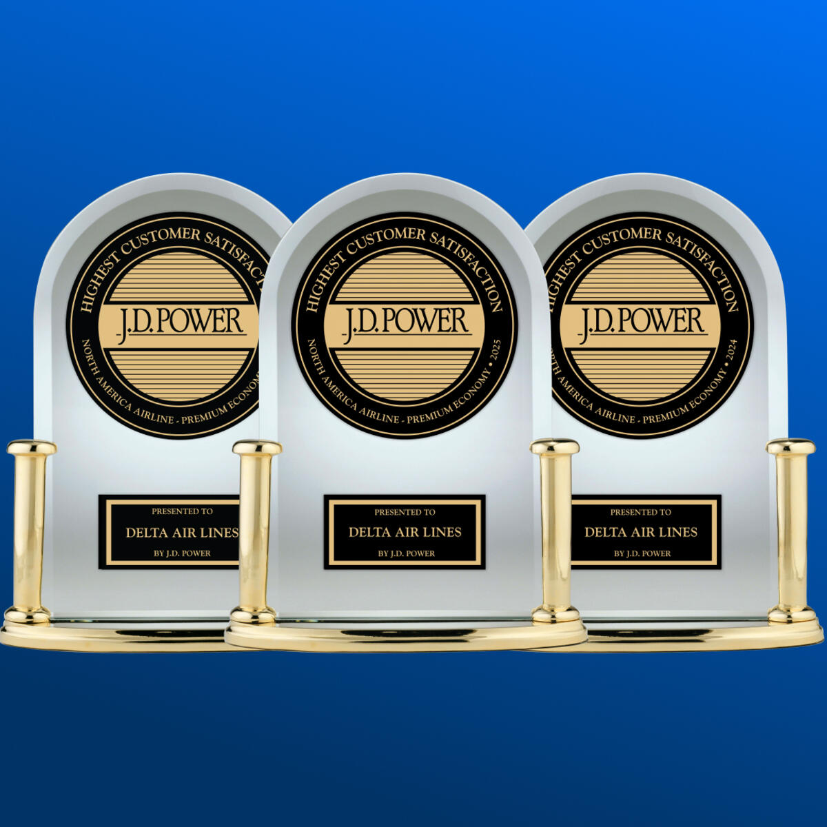 Three J.D. Power trophies against a blue background