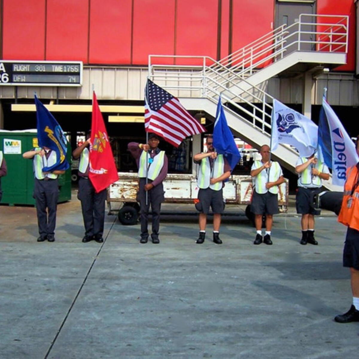 Honor Guard members standing in line with flags