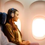 A woman enjoys In-Flight Entertainment onboard a Delta flight.