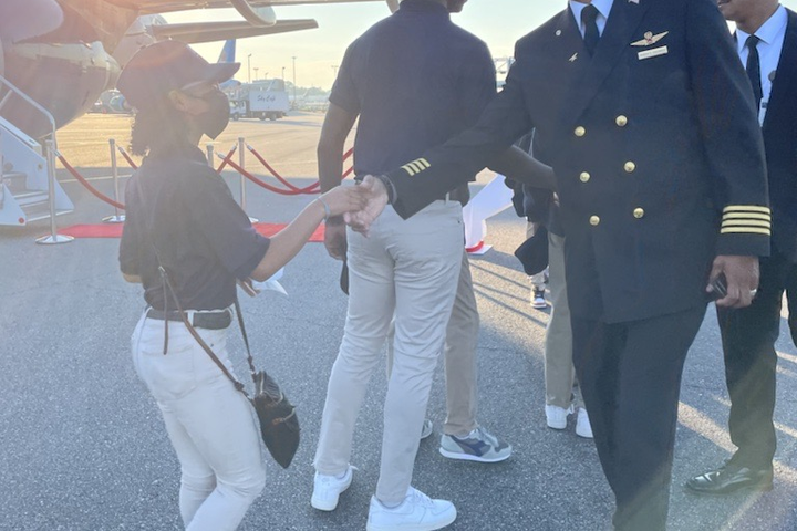 A Delta pilot greets a student participating in the 2022 Dream Flight