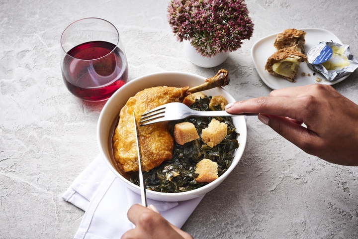 Roasted chicken with smoked collard greens, a Delta first class meal offering, created by Chef Mashama Bailey