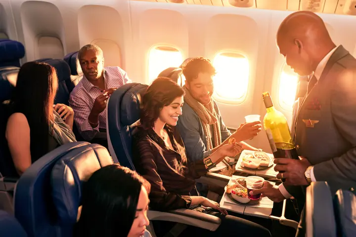 Delta Flight Attendant Robert F. serves customers on board.