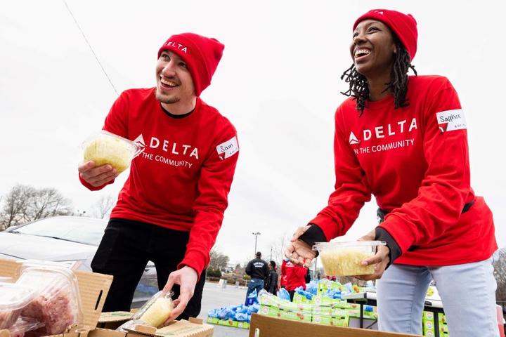 Two Delta employees volunteer at Hosea Helps in Atlanta during the annual "Hosea Helps Festival of Services" event.