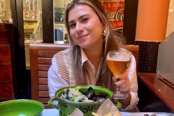 A Delta employee enjoys a meal of moules frites in Brussels