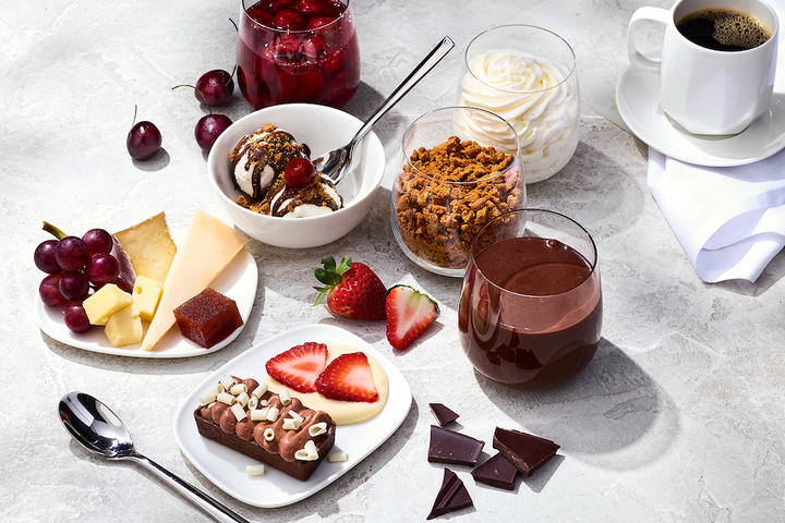 The Delta One dessert carts features a variety of treats like opera cake with chocolate ganache; Cowgirl Creamery wagon wheel, Midnight Moon gouda, and grapes.