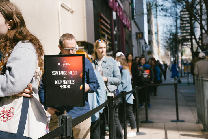 Visitors eagerly wait to enter the Delta Lounge, a branded pop-up experience exclusively for SkyMiles members featuring fast, free Delta Sync Wi-Fi, global fan-favorite beverages from Delta partner Starbucks, custom limited-edition Delta x SXSW merch, and more.&nbsp;&nbsp;