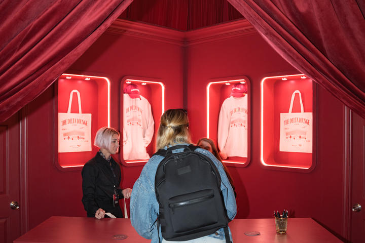 A SkyMiles member stops by the Gifting Salon in the Delta Lounge, an exclusive merch station where lounge goers were given a ticket to redeem custom limited-edition Delta x SXSW merchandise such as hats, tote bags and sweatshirts.