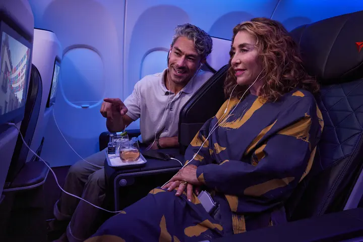 Delta customers sitting in First Class enjoy seatback entertainment.