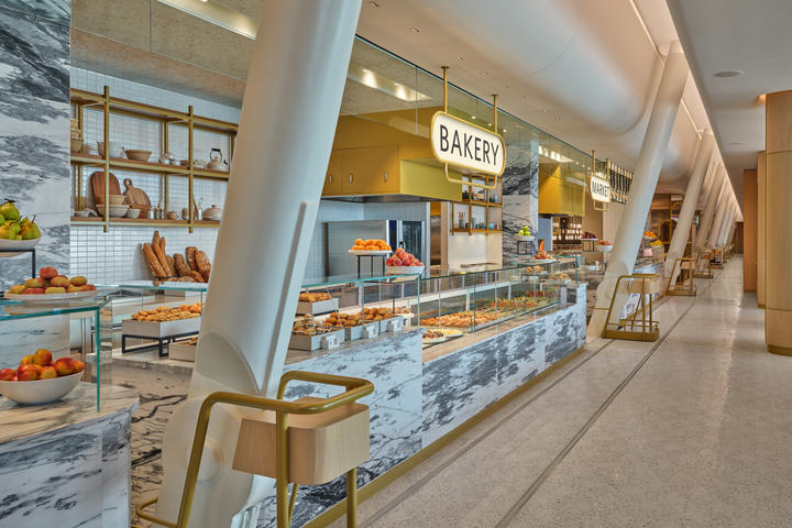 Fan-shaped marble mosaic tiles in the Market dining area at The Delta Lounge-JFK pay tribute to famed New York brasseries. The penny-round ceiling over the food counter is a hat-tip to the original JFK terminal, designed by famed architect Eero Saarinen.