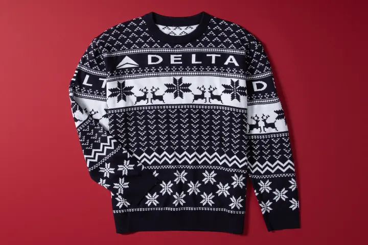Show off your love for travel this winter with our Navy Delta Holiday Sweater. Cozy and colorful, this sweater is perfect for any festive occasion. 