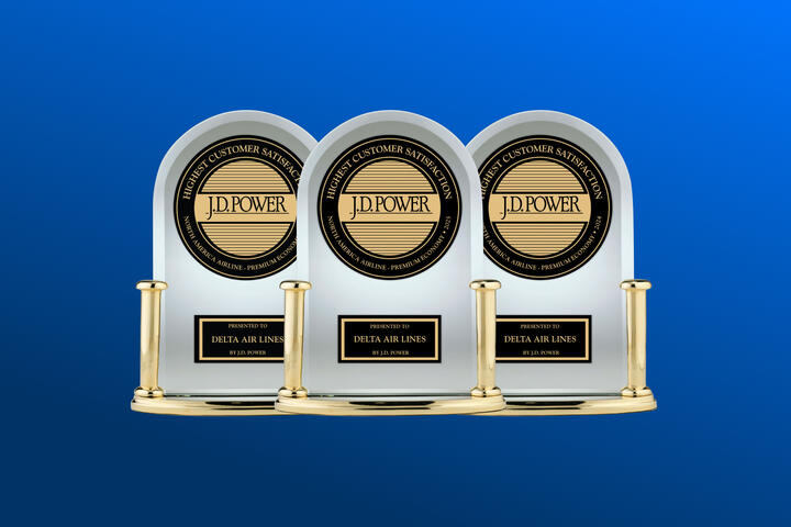 Three J.D. Power trophies against a blue background