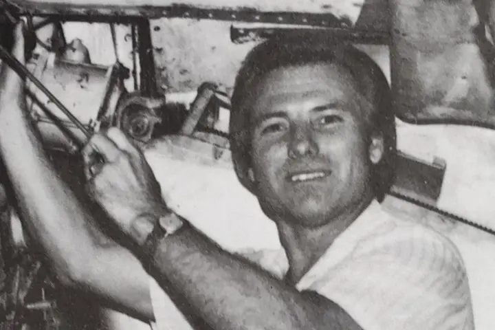 Black and white photo of Jimmy working on an airplane