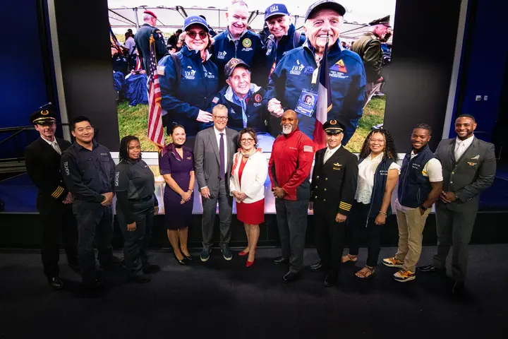 Group photo of Virginie Durr, Ed Bastian and other Delta employees.