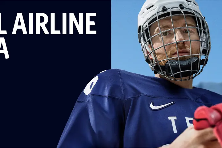 Promotional graphic with text reading ‘The Official Airline of Team USA’ and ‘Declan Farmer – Sled Hockey,’ along with Delta, Olympic and Paralympic logos. On the right, athlete wears blue hockey uniform holding red gloves with snowy mountains in background
