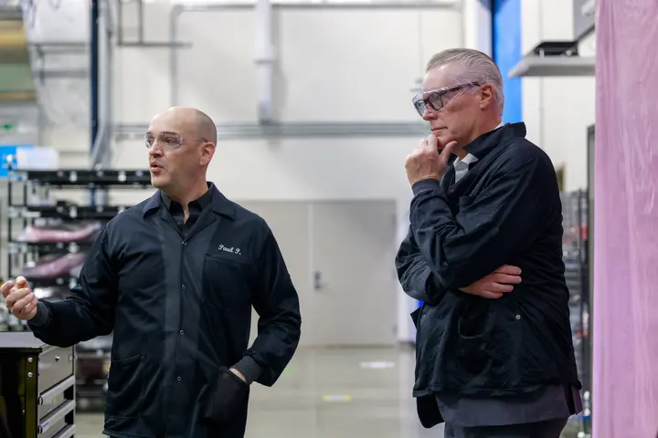 Ed Bastian and Amazon Leo employee standing in industrial facility.