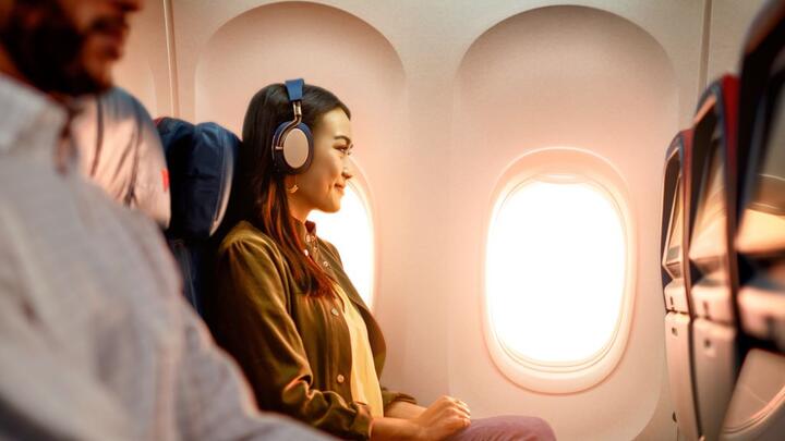 A woman enjoys In-Flight Entertainment onboard a Delta flight.