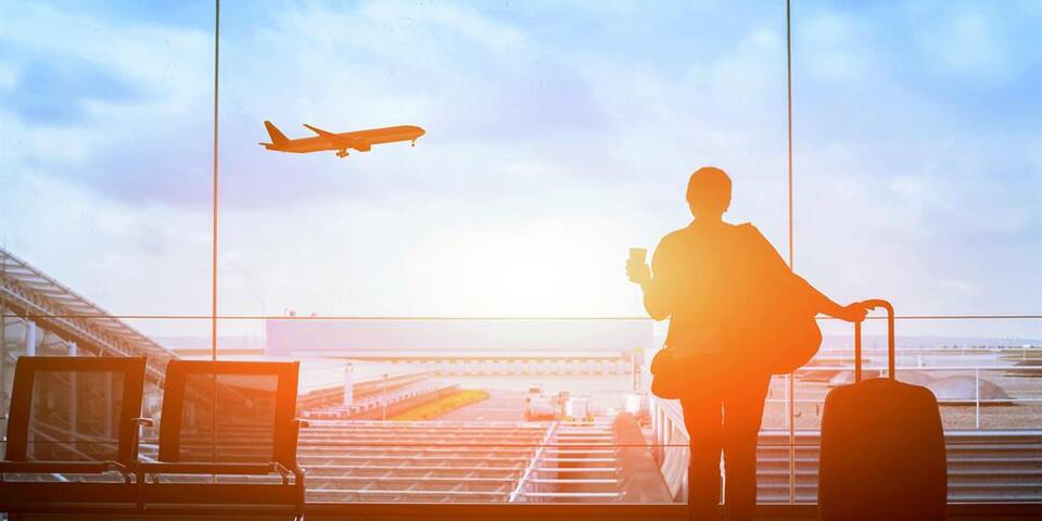 Customer watches plane at sunset