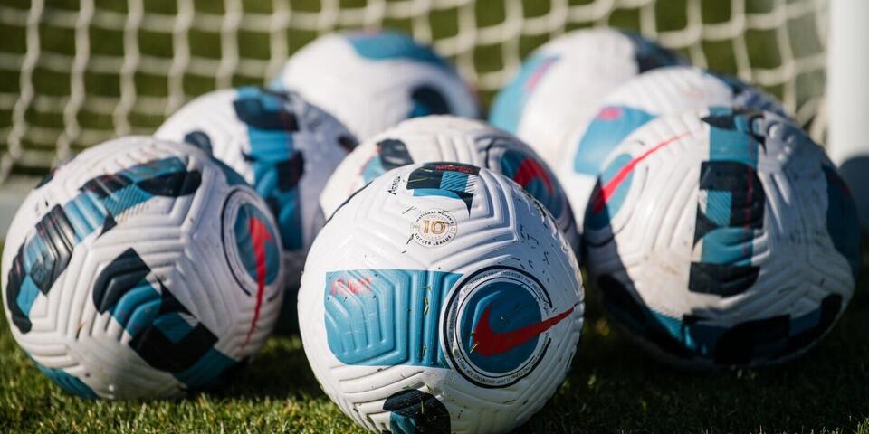 Arrary of soccer balls announcing partnership with National Women’s Soccer League 