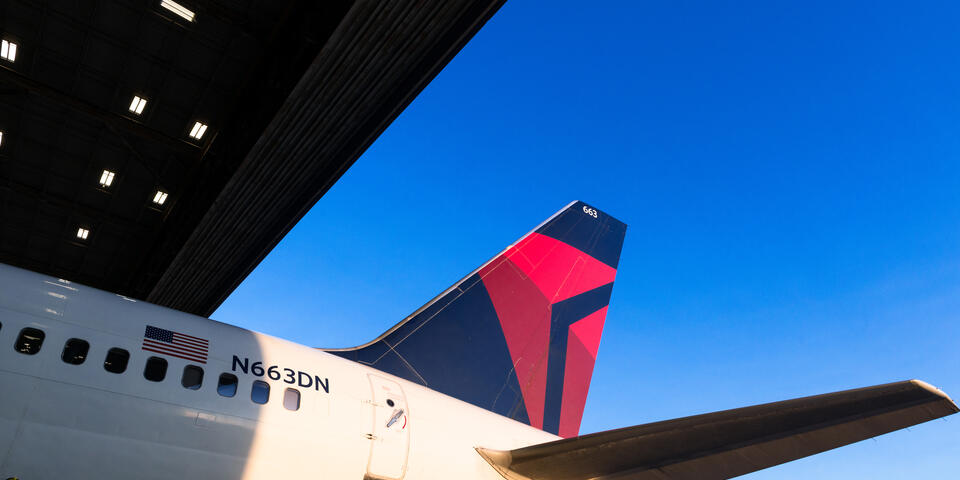Tail of a 757-200 in an airport hangar