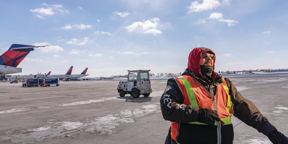 A Delta Aircraft Load Agent works in winter conditions at Minneapolis-St. Paul International Airport (MSP).