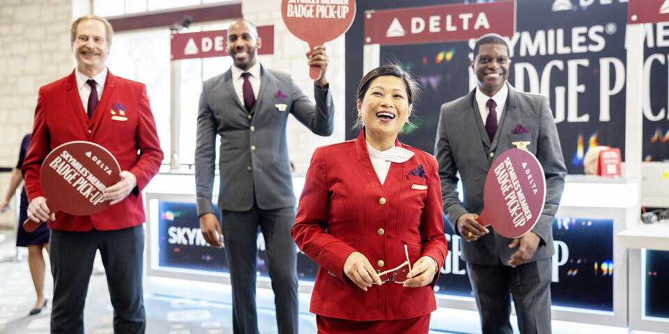 Austin-based flight attendants and Red Coats assist in assisting guests with a dedicated badge pick-up area for SkyMiles Members at the Austin Convention Center Rotunda Foyer during SXSW 2024.