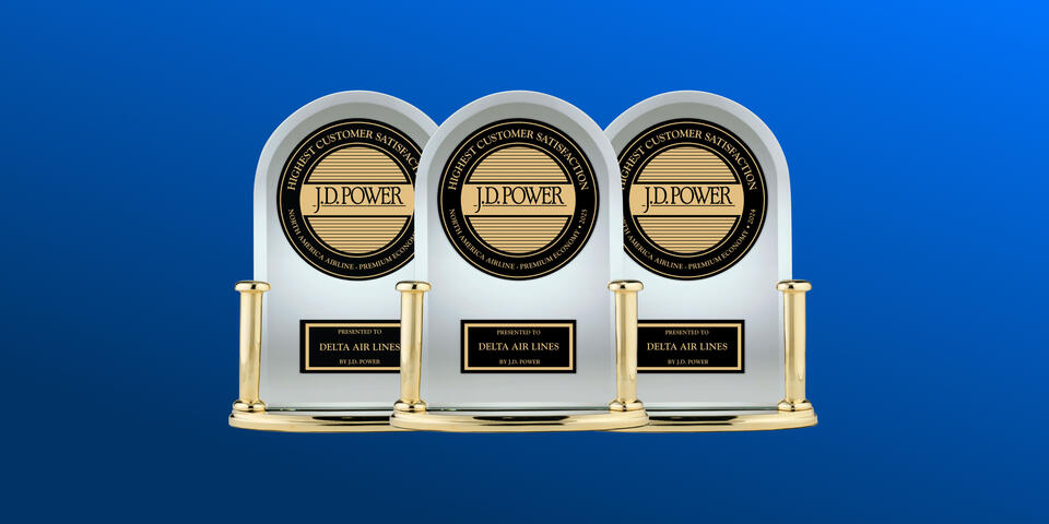 Three J.D. Power trophies against a blue background