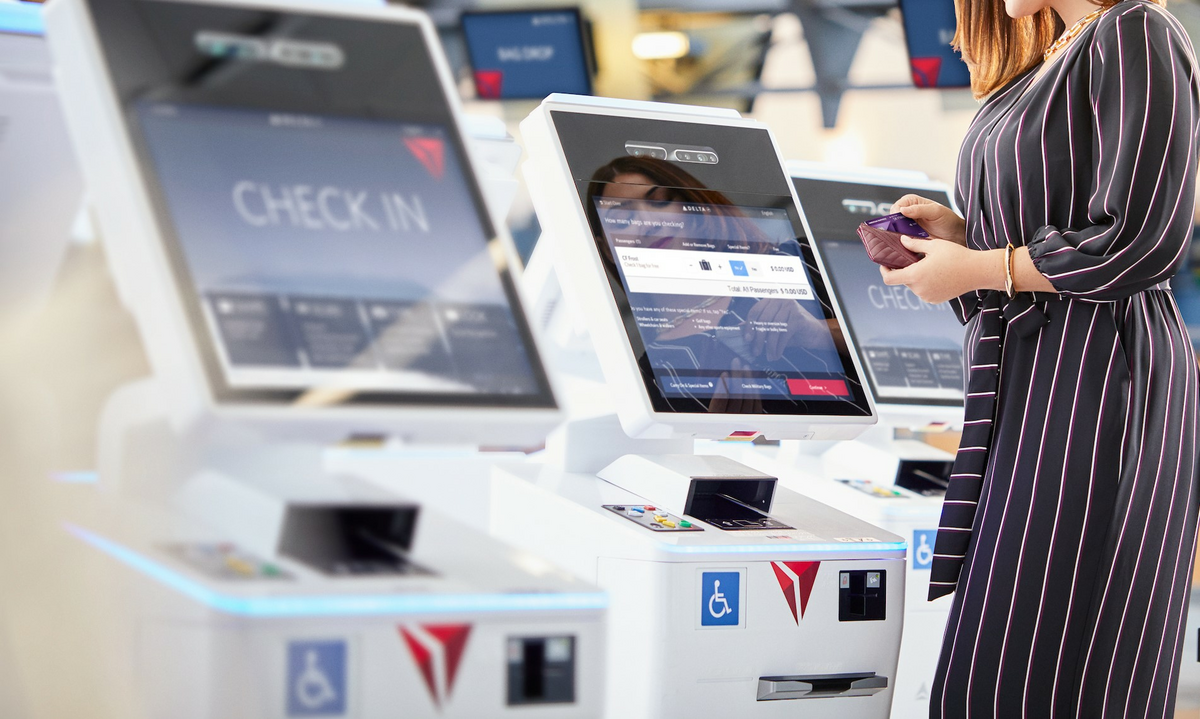 Customer checking in at a kiosk using their American Express card.