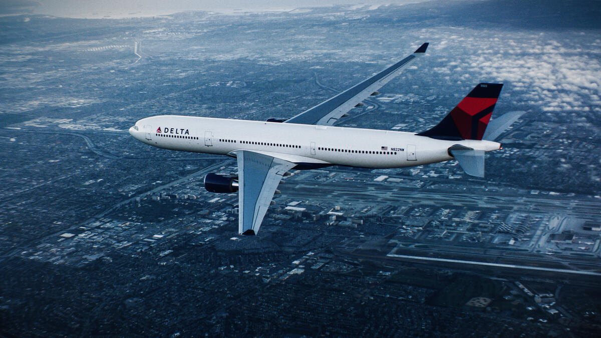 A330-300 in flight over city