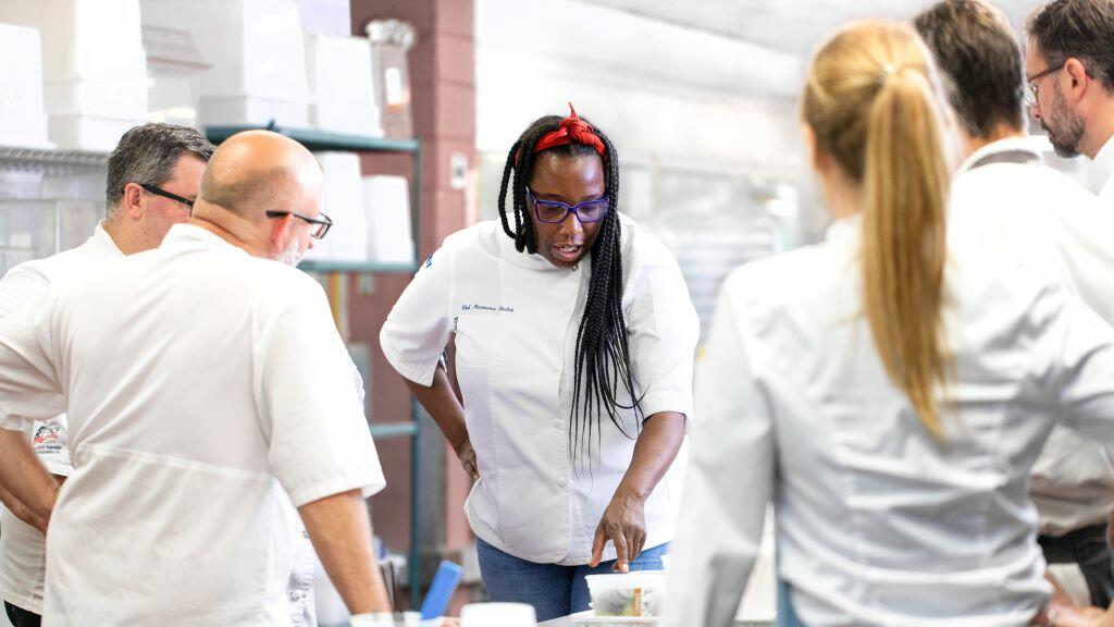 Chef Masama Bailey, whose signature Southern flair is now featured on Delta flights departing Atlanta, works with her team in the kitchen.