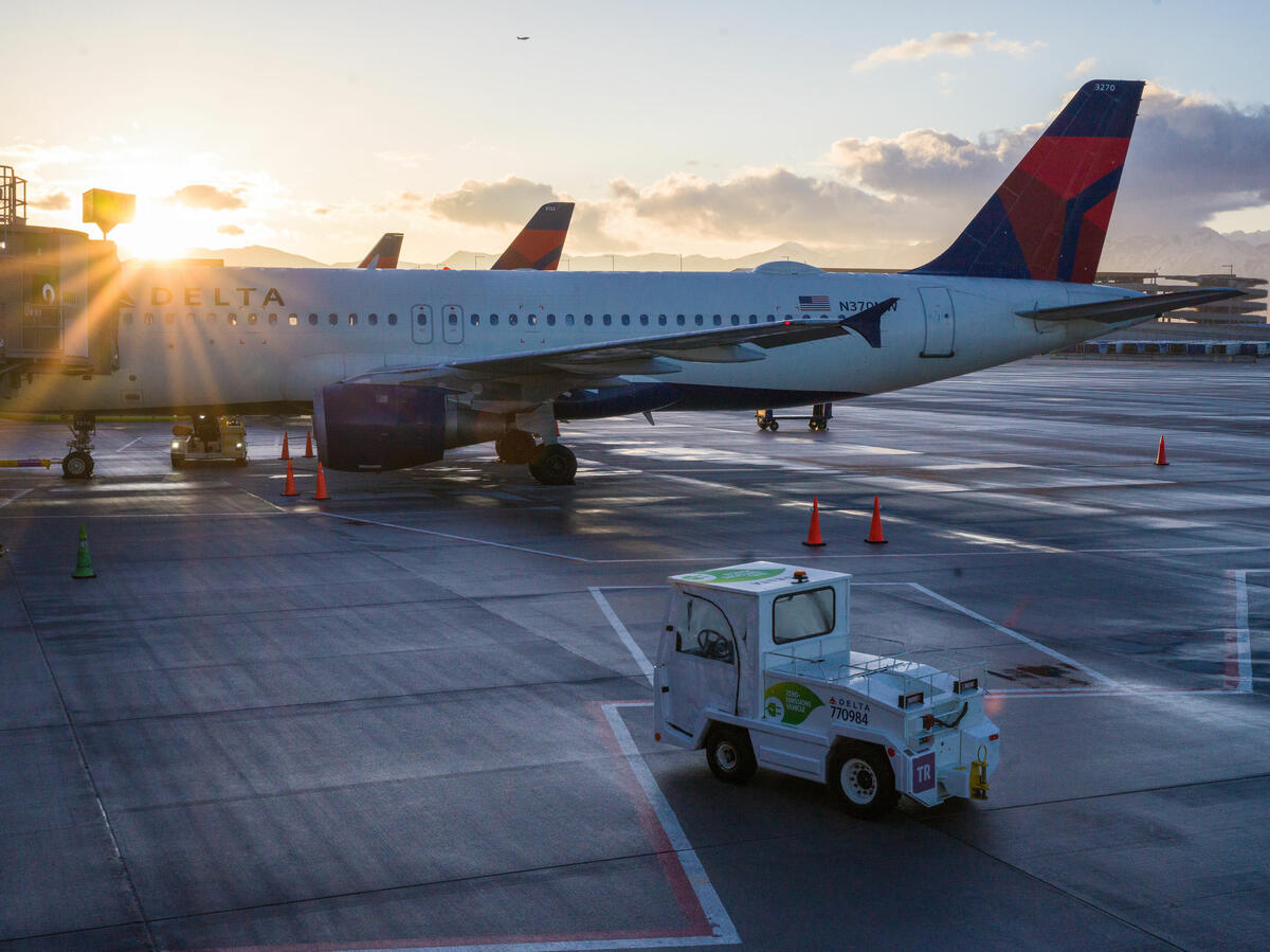An electric bag tractor with a “zero-emission” vehicle decal is seen on the ramp at Salt Lake City International Airport (SLC).