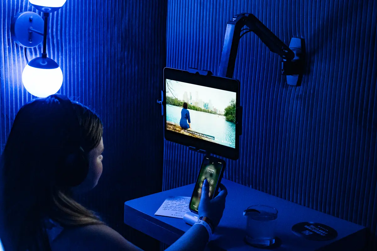 A SkyMiles member enjoys locally curated content in the Delta Sync space, an experience designed to recall Delta’s seatback in-flight entertainment screens and Fast, Free Wi-Fi powered by T-Mobile.