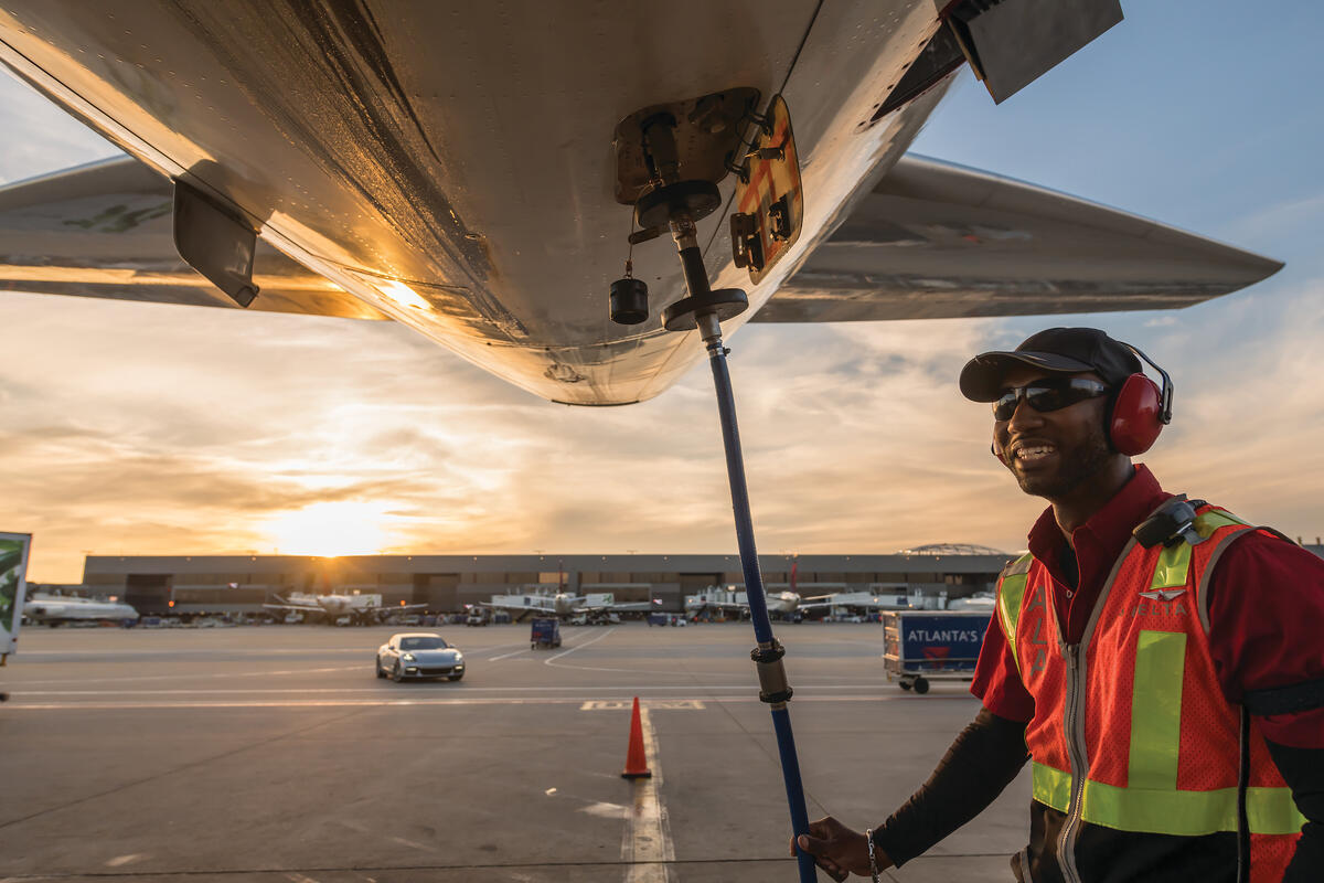 Ramp agent working under an aircraft