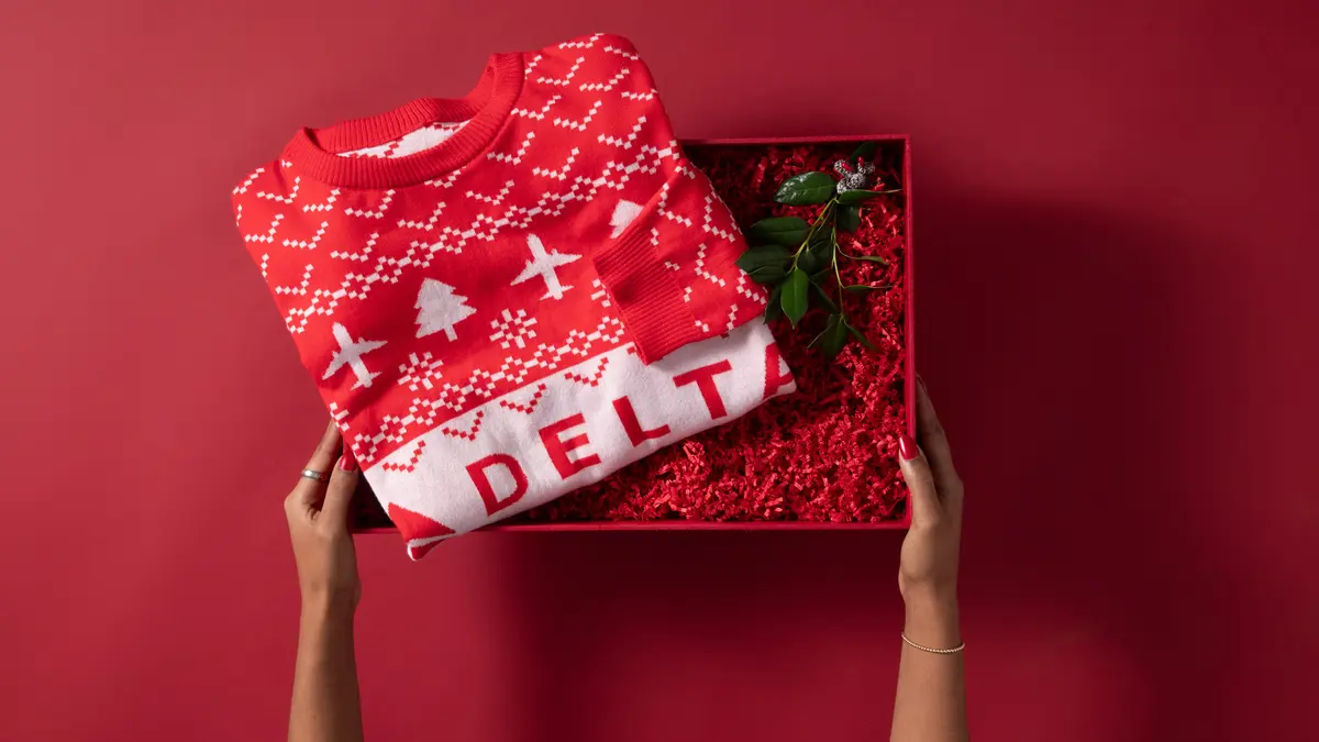 Show off your love for travel this winter with our Red Delta Holiday Sweater. Cozy and colorful, this sweater is perfect for any festive occasion. 